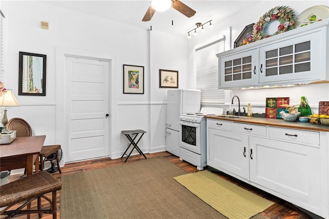 kitchen featuring dark hardwood / wood-style flooring, white cabinetry, sink, white gas range oven, and butcher block countertops