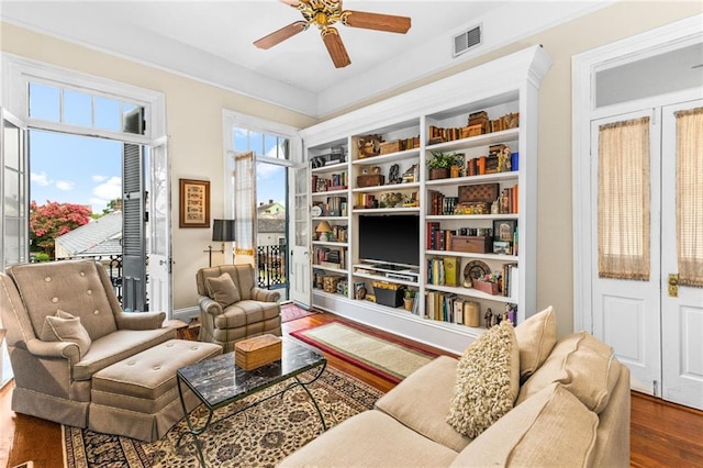 sitting room featuring ceiling fan and dark hardwood / wood-style flooring