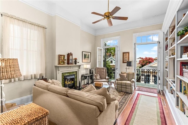 interior space featuring ceiling fan, wood-type flooring, and a premium fireplace