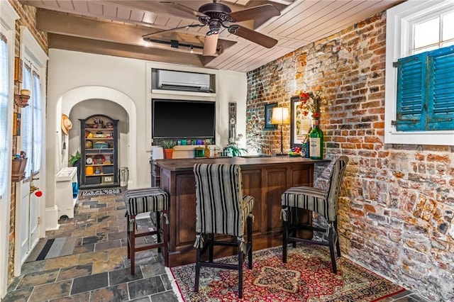 bar with brick wall, a wall mounted AC, wood ceiling, and ceiling fan