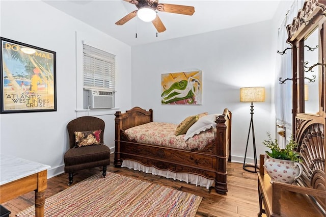 bedroom with cooling unit, wood-type flooring, and ceiling fan