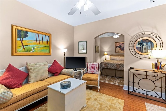 living room with hardwood / wood-style floors and ceiling fan