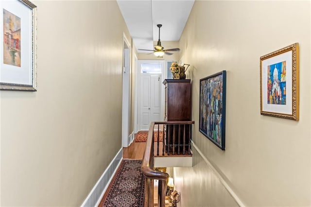 hallway with hardwood / wood-style floors