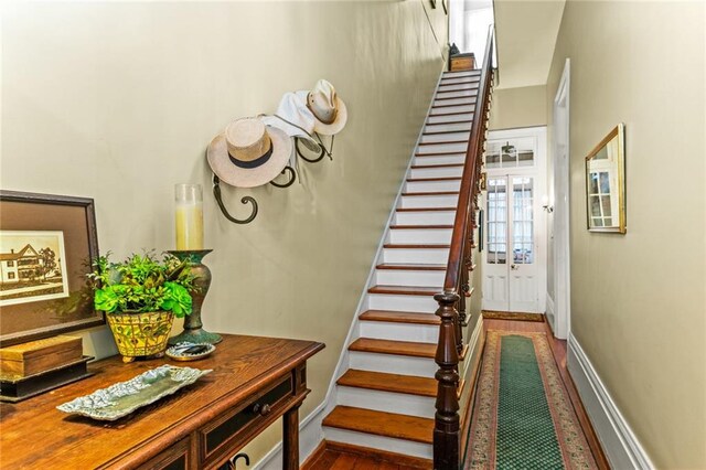 staircase featuring wood-type flooring