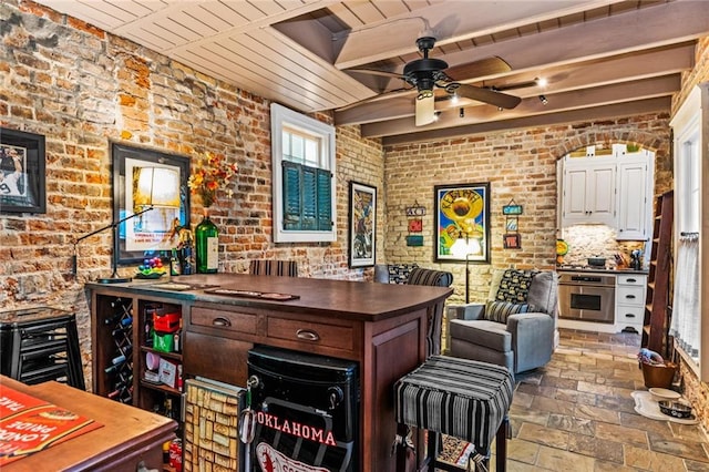 bar featuring oven, backsplash, wooden ceiling, brick wall, and ceiling fan