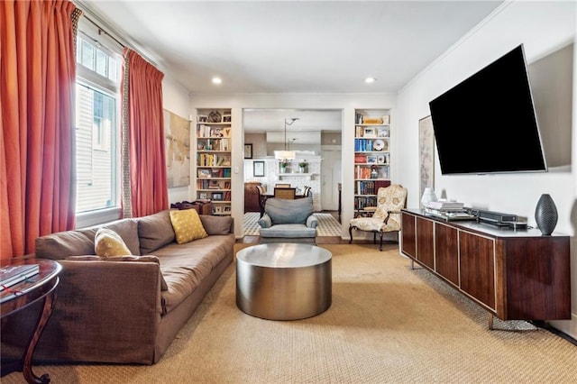 living room featuring ornamental molding, light colored carpet, and built in features