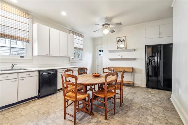 dining area with crown molding, sink, and ceiling fan