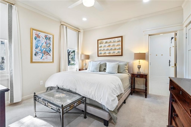 carpeted bedroom featuring ceiling fan and crown molding