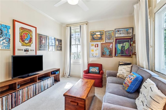 living room with crown molding, light carpet, and ceiling fan