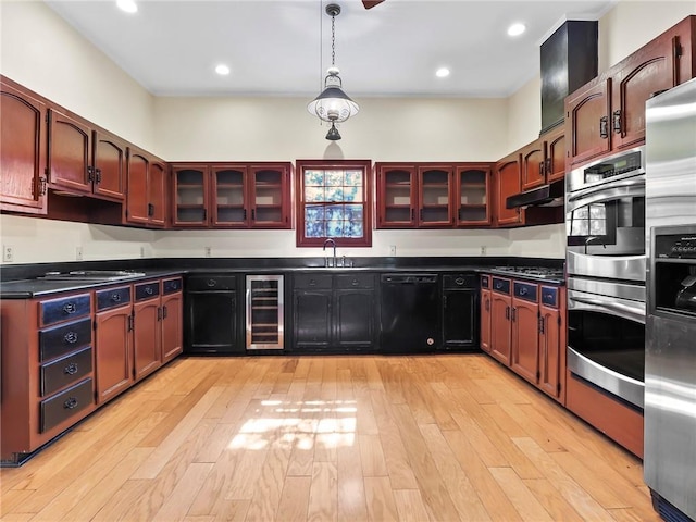 kitchen with pendant lighting, sink, wine cooler, light wood-type flooring, and appliances with stainless steel finishes