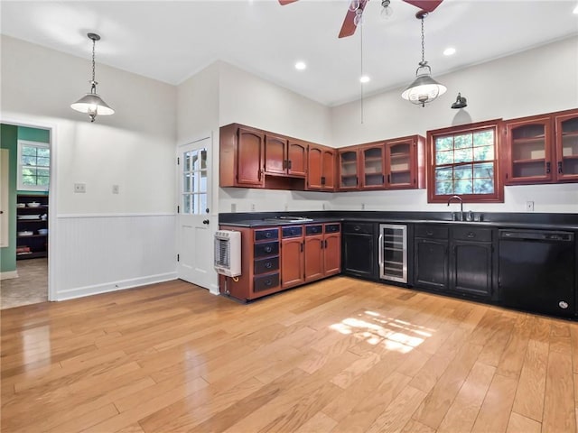 kitchen with pendant lighting, plenty of natural light, light wood-type flooring, and black dishwasher