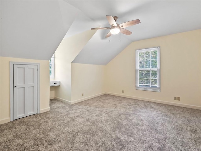 bonus room featuring ceiling fan, lofted ceiling, and light carpet