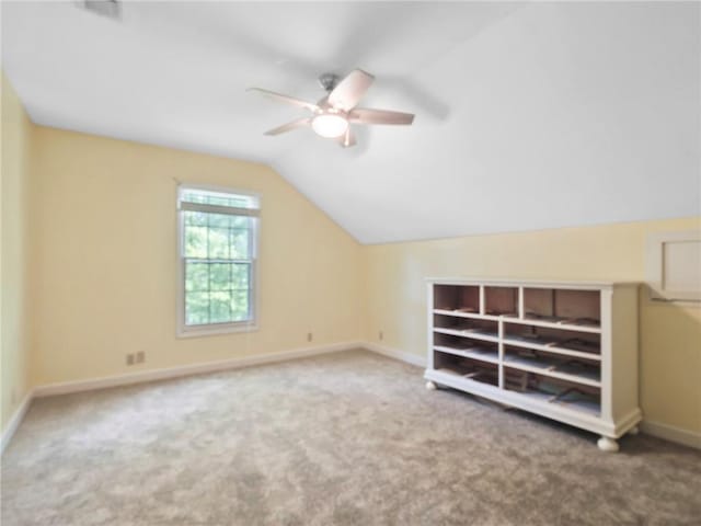 additional living space featuring carpet, vaulted ceiling, and ceiling fan