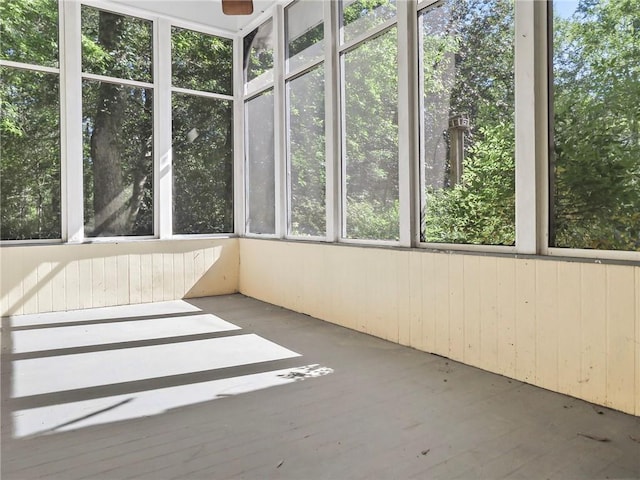 unfurnished sunroom with ceiling fan