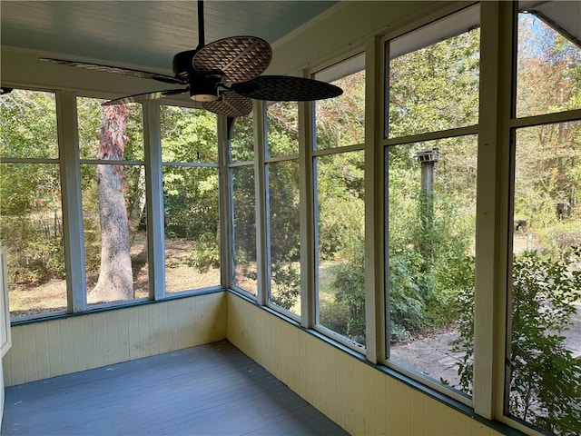 unfurnished sunroom with ceiling fan and a healthy amount of sunlight