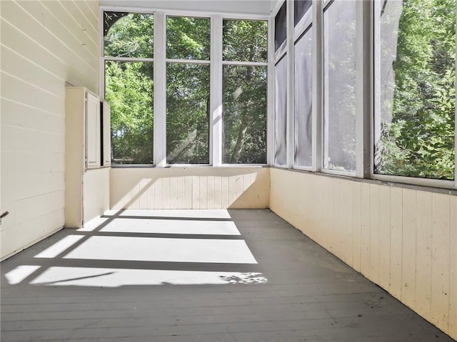 unfurnished sunroom featuring a wealth of natural light