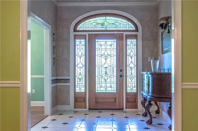 foyer featuring crown molding