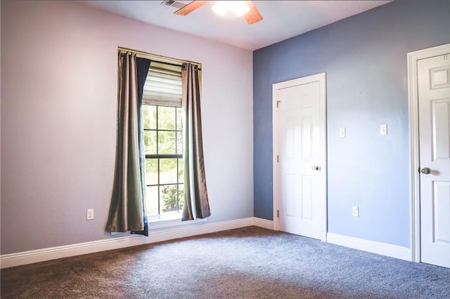 carpeted spare room with ceiling fan