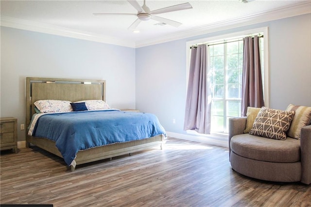 bedroom featuring ceiling fan, crown molding, and hardwood / wood-style floors