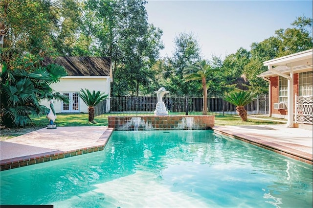 view of pool featuring french doors, a patio, and pool water feature