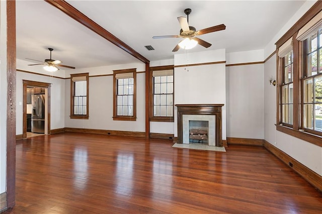 unfurnished living room with ceiling fan, a fireplace, and dark hardwood / wood-style floors