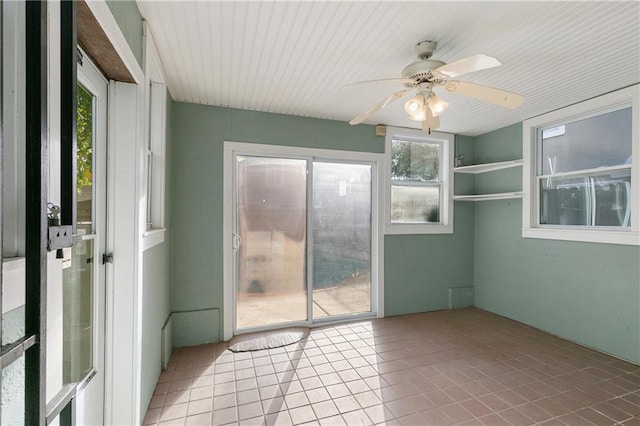 unfurnished sunroom featuring ceiling fan