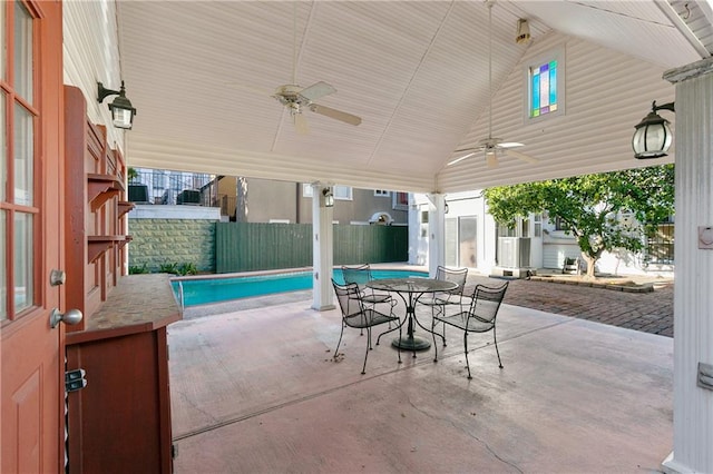 view of patio / terrace with a fenced in pool and ceiling fan