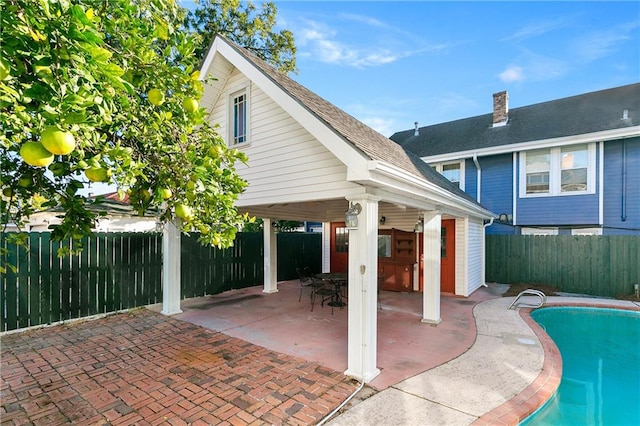 exterior space with a patio and a fenced in pool