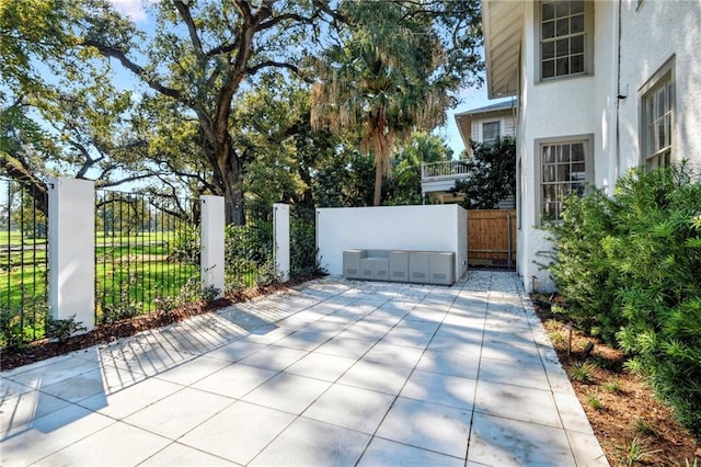 7008 Chestnut St Unit 102, New Orleans, LA 70118 - view of patio / terrace with a gate