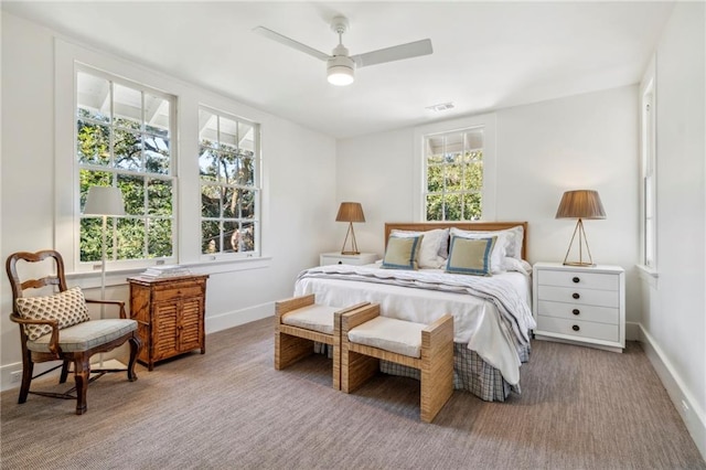bedroom with baseboards, visible vents, and ceiling fan