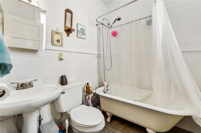 bathroom featuring shower / bath combination with curtain and toilet