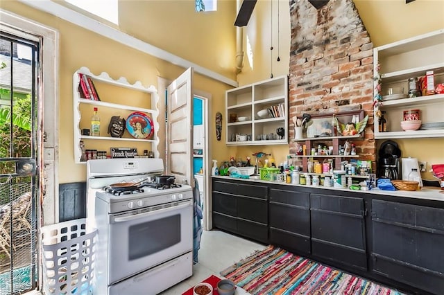 kitchen featuring white range with gas cooktop