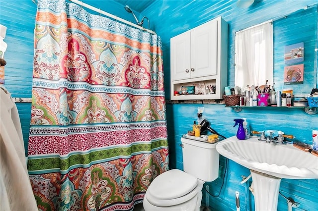 bathroom with a shower with curtain and toilet