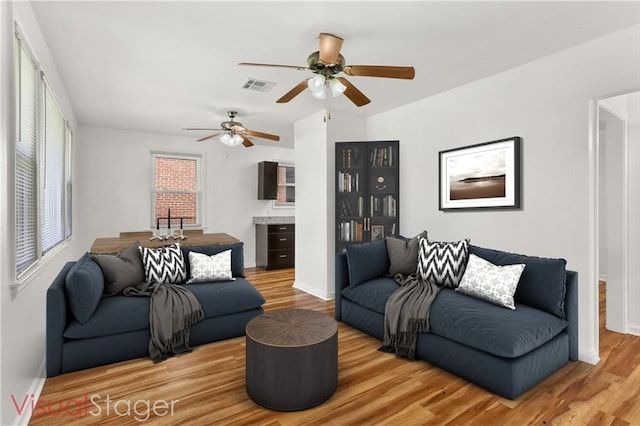 living room with ceiling fan and hardwood / wood-style floors