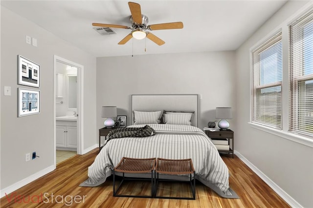 bedroom with hardwood / wood-style floors, ceiling fan, and ensuite bathroom