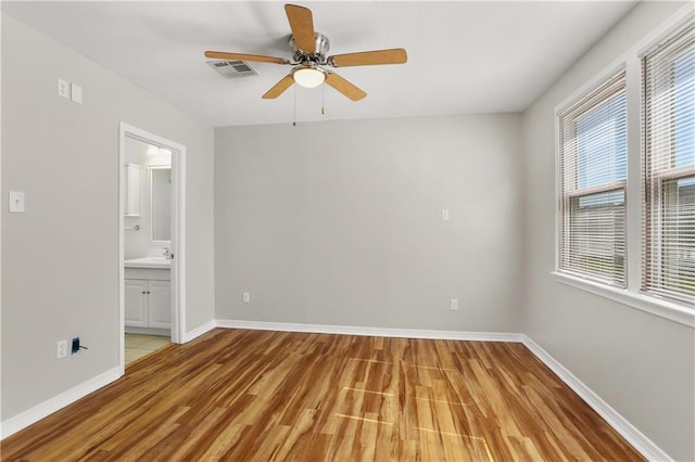 unfurnished bedroom featuring ceiling fan, connected bathroom, and light hardwood / wood-style floors