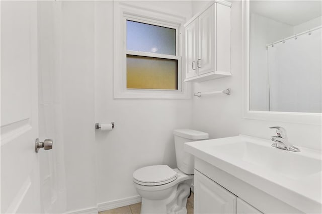 bathroom featuring tile patterned floors, vanity, and toilet