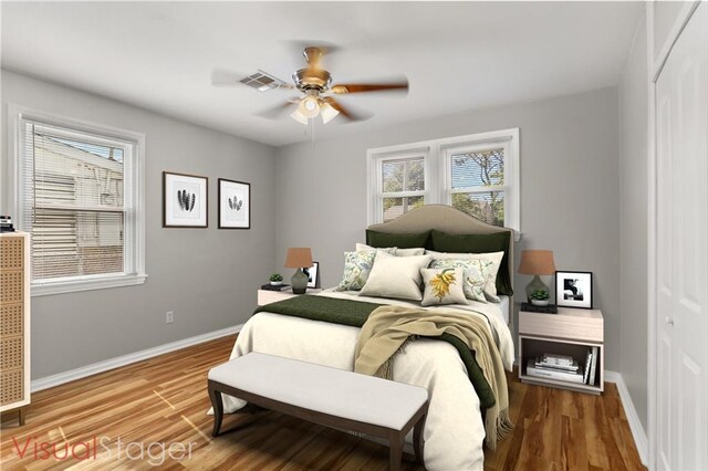 bedroom with hardwood / wood-style flooring, ceiling fan, and a closet