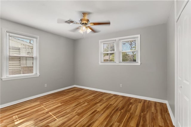 empty room featuring ceiling fan and hardwood / wood-style floors