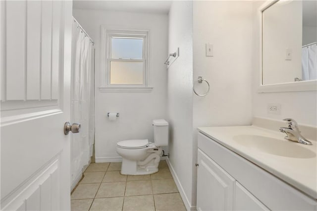 bathroom featuring tile patterned flooring, vanity, and toilet