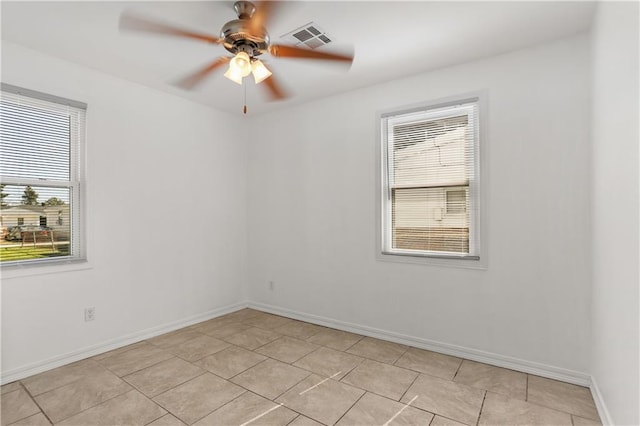 spare room with light tile patterned floors and ceiling fan