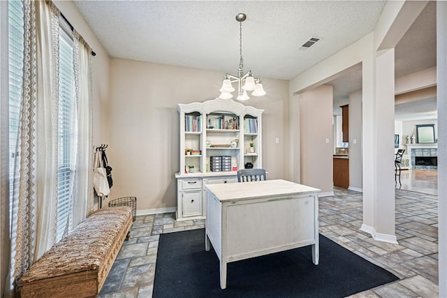 dining area featuring a textured ceiling and a chandelier