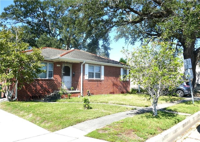bungalow-style home with a front lawn and brick siding