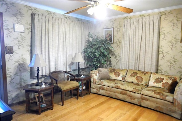 living room featuring ceiling fan, hardwood / wood-style flooring, and ornamental molding