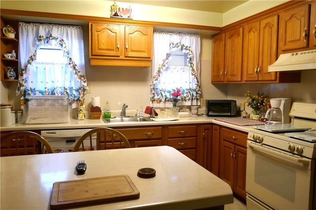 kitchen featuring a wealth of natural light, sink, and gas range gas stove