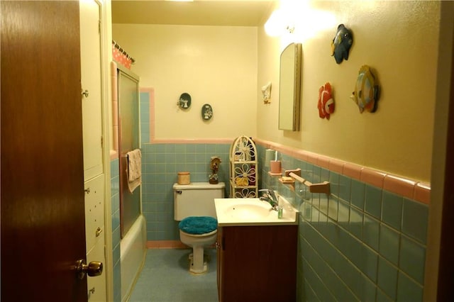 full bathroom featuring tile walls, vanity, shower / tub combo, and toilet