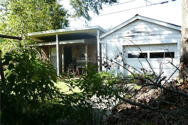 view of side of home featuring a garage