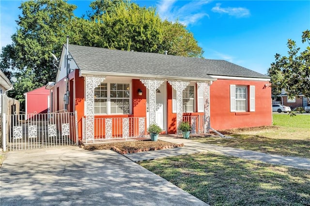 bungalow-style home with covered porch and a front yard