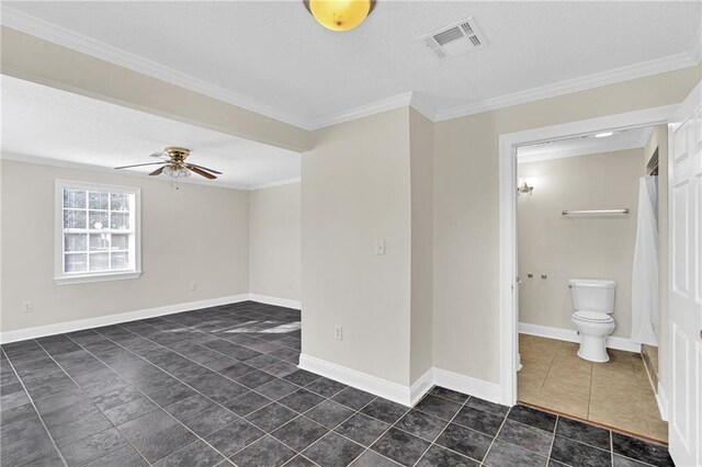 tiled empty room featuring ceiling fan and crown molding