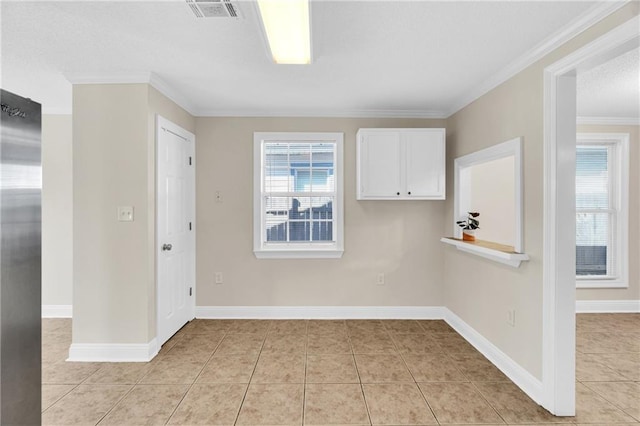 tiled empty room featuring ornamental molding